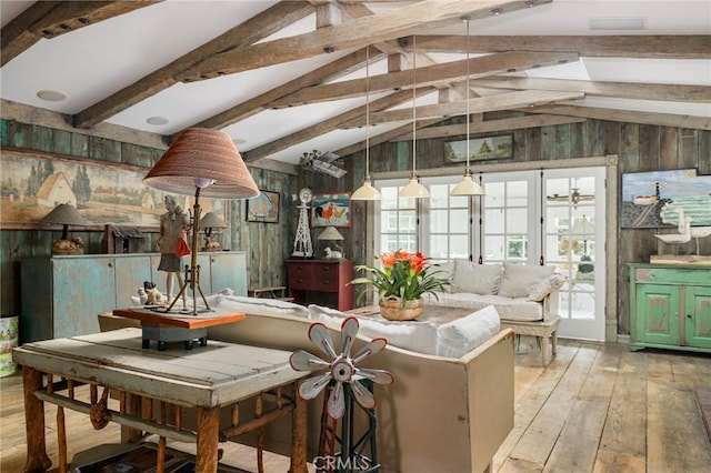 interior space featuring wooden walls, vaulted ceiling with beams, and light wood-type flooring