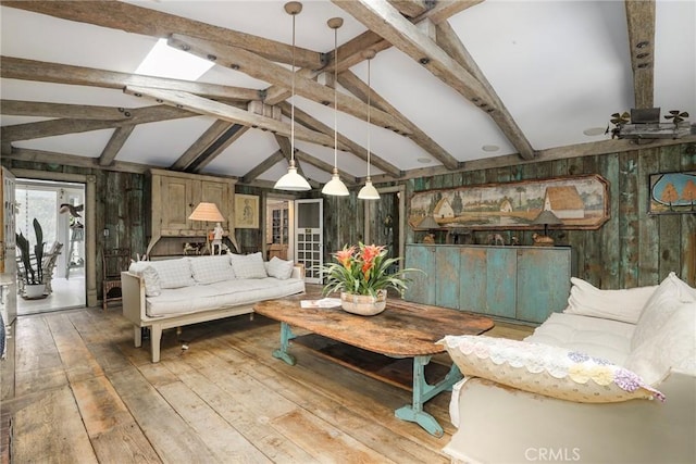 living room featuring lofted ceiling with beams, light hardwood / wood-style floors, and wood walls