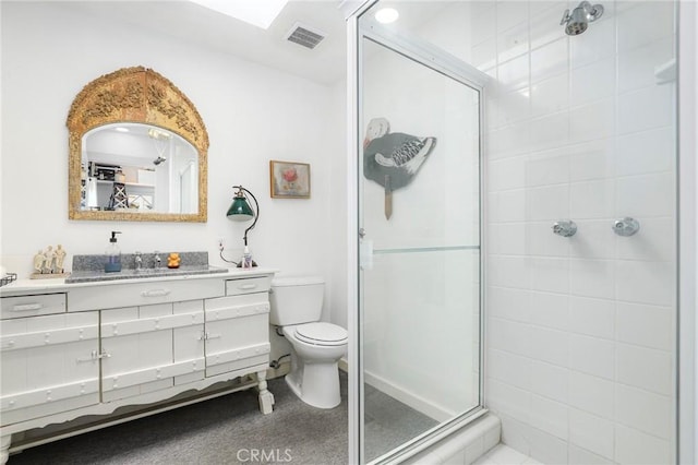 bathroom with vanity, a shower with shower door, and toilet