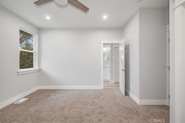 carpeted empty room featuring ceiling fan