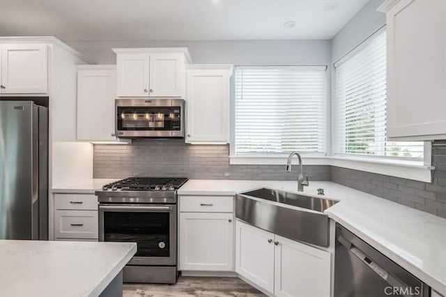 kitchen featuring sink, white cabinets, and appliances with stainless steel finishes