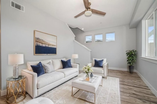 living room featuring hardwood / wood-style flooring and ceiling fan