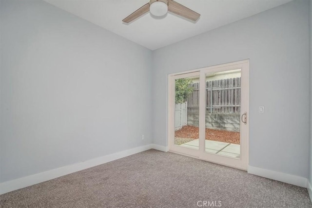 unfurnished room featuring ceiling fan and carpet