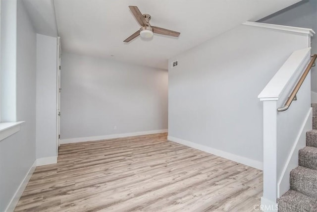 spare room with ceiling fan and light hardwood / wood-style floors