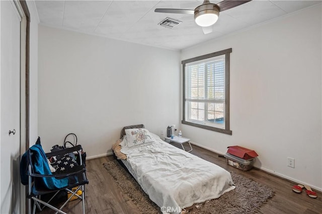 bedroom featuring ceiling fan and dark hardwood / wood-style flooring