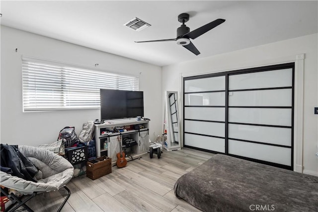 bedroom with ceiling fan and light wood-type flooring