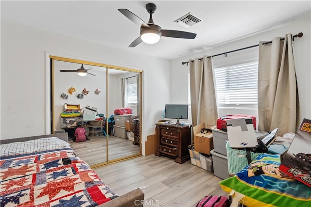 bedroom featuring a closet, ceiling fan, and light hardwood / wood-style flooring