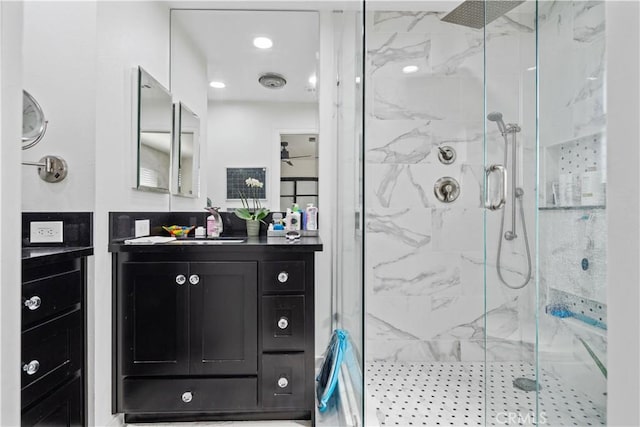 bathroom featuring vanity and an enclosed shower