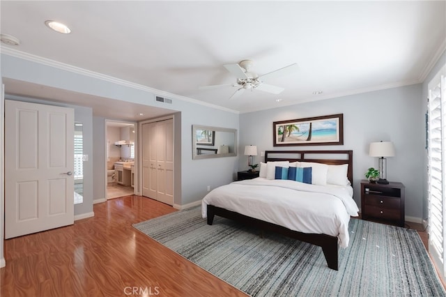 bedroom with ornamental molding, a closet, and light wood-type flooring