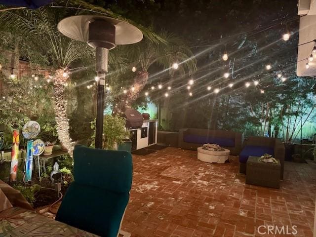 view of patio / terrace with an outdoor living space with a fire pit