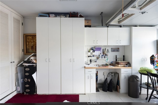 kitchen featuring white cabinetry and light tile patterned floors