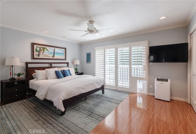 bedroom with ornamental molding, ceiling fan, and light hardwood / wood-style flooring