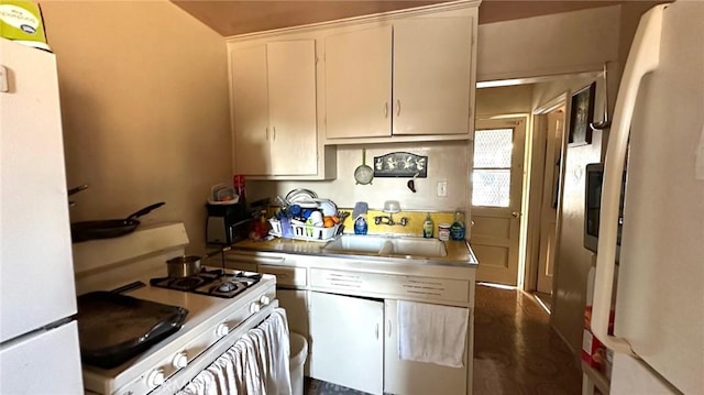 kitchen featuring white cabinetry, sink, and white appliances