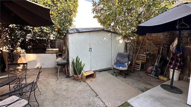 view of patio / terrace featuring a grill and a shed