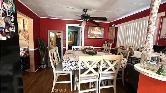 dining area with wood-type flooring and ceiling fan