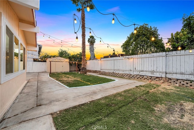 yard at dusk with a patio area