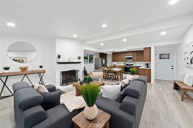 living room with a fireplace and light hardwood / wood-style floors