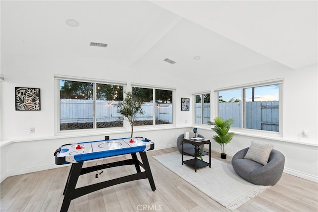 rec room featuring vaulted ceiling with beams and light hardwood / wood-style flooring