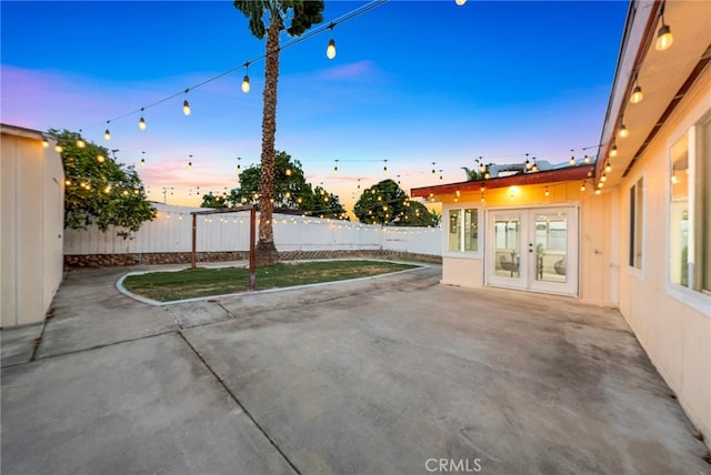 patio terrace at dusk featuring french doors