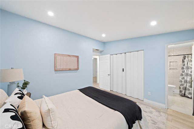 bedroom featuring connected bathroom and a closet