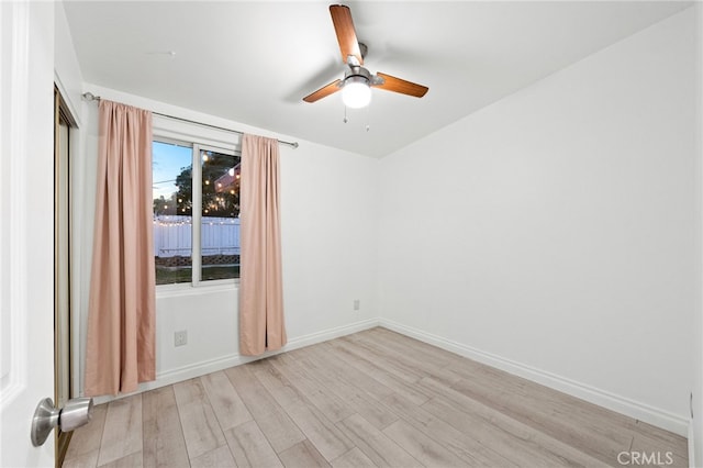 empty room with ceiling fan and light wood-type flooring