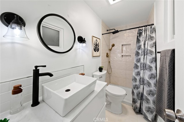 bathroom featuring tile patterned flooring, sink, and toilet