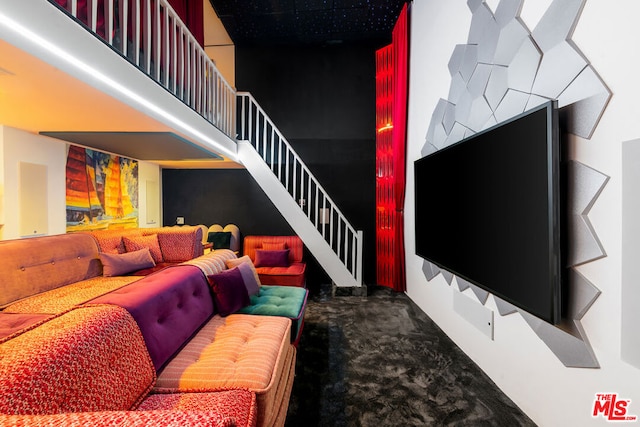 living room with carpet floors and a high ceiling