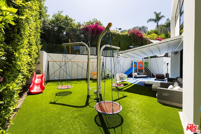 view of play area with an outdoor hangout area and a lawn