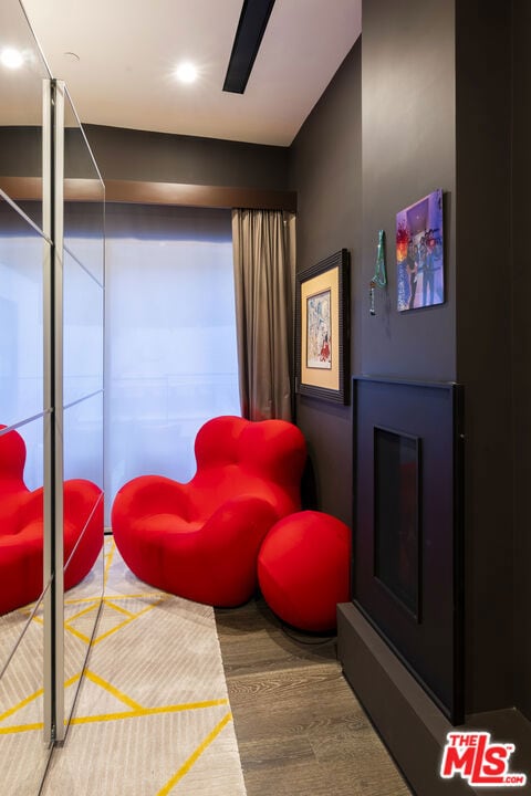 sitting room with hardwood / wood-style flooring