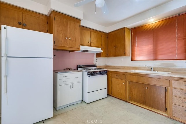 kitchen with ceiling fan, sink, and white appliances