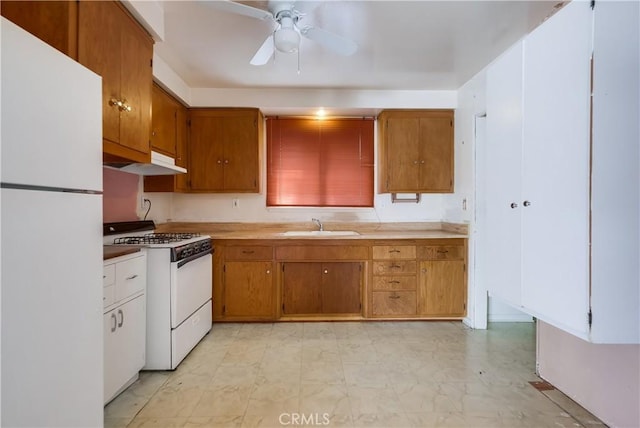 kitchen featuring ceiling fan, sink, and white appliances