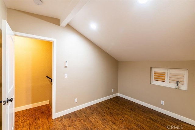 additional living space featuring dark hardwood / wood-style floors and lofted ceiling with beams