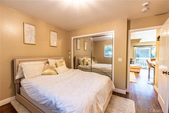 23821 Hillhurst Dr W Unit 44, Laguna Niguel, CA 92677 - bedroom with dark wood-style floors, baseboards, and a closet