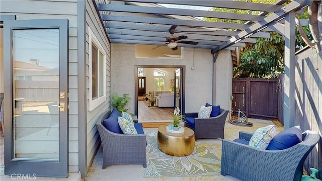 view of patio featuring outdoor lounge area, ceiling fan, and a pergola