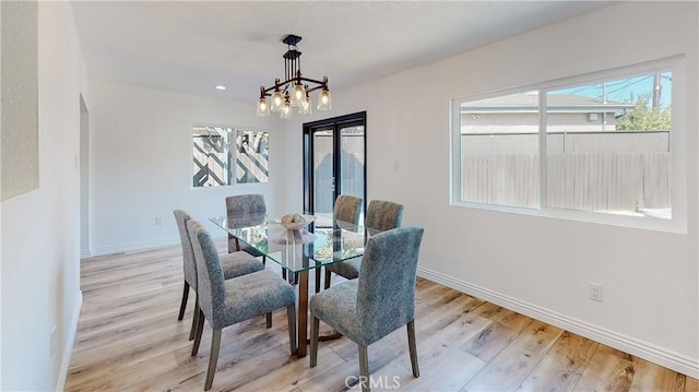 dining space featuring a chandelier and light hardwood / wood-style flooring