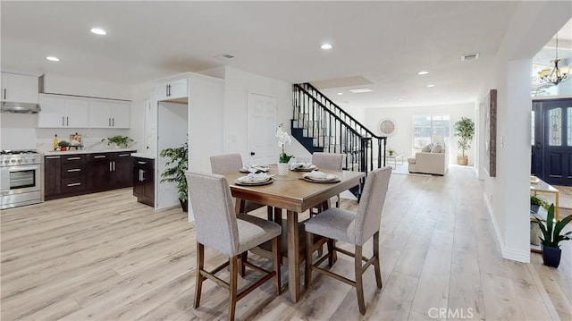 dining room featuring a notable chandelier and light hardwood / wood-style floors