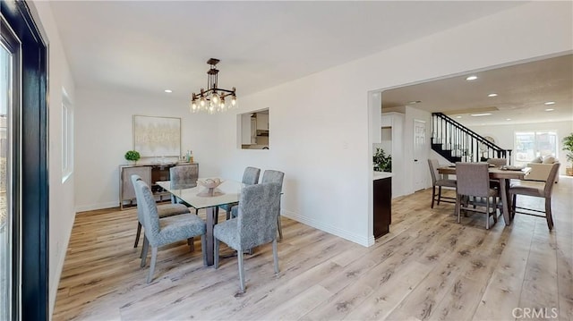 dining room featuring an inviting chandelier and light wood-type flooring