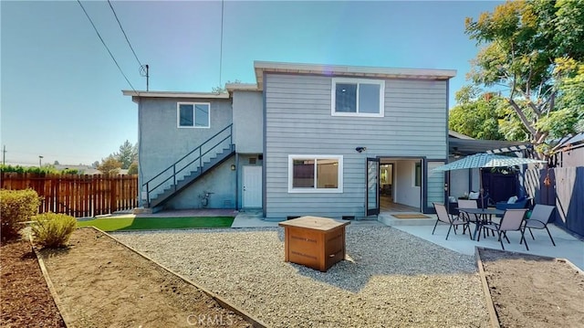 rear view of property featuring a patio area