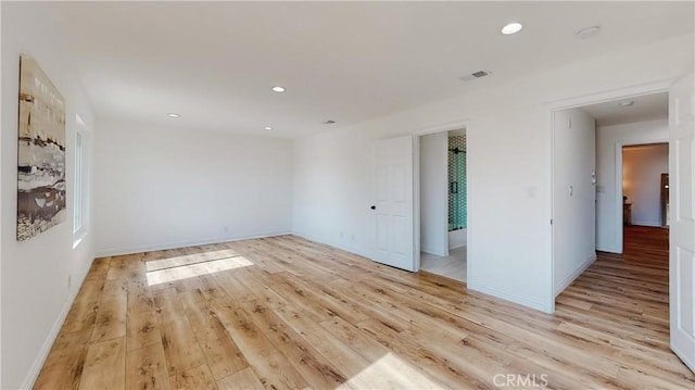 spare room with light hardwood / wood-style flooring