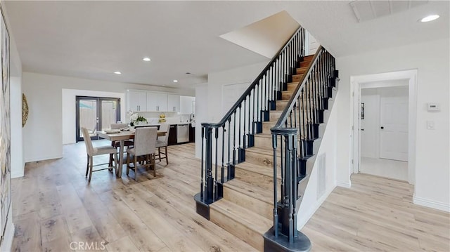 dining area featuring french doors and light hardwood / wood-style flooring