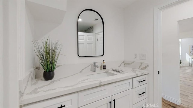 bathroom with hardwood / wood-style flooring and vanity