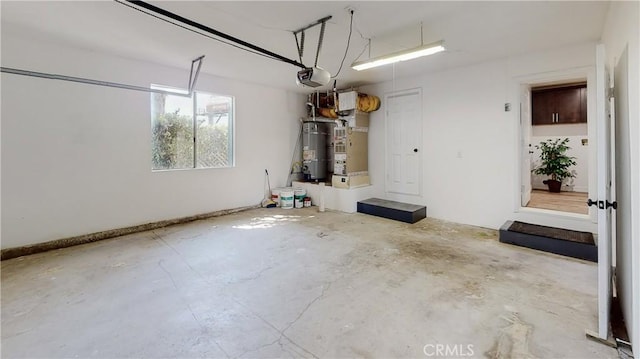 garage featuring heating unit, strapped water heater, and a garage door opener