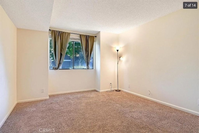 unfurnished room featuring a textured ceiling and carpet flooring