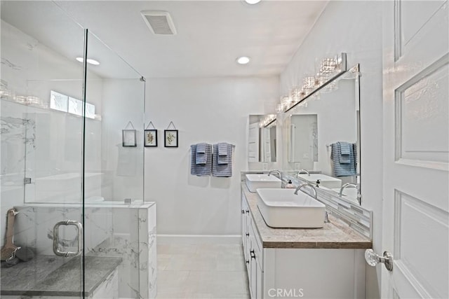 bathroom with vanity and a shower with door