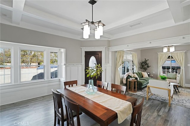 dining space with dark wood-type flooring, beamed ceiling, and plenty of natural light