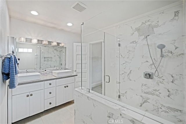 bathroom featuring vanity and an enclosed shower