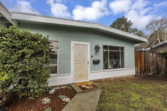 doorway to property featuring a yard