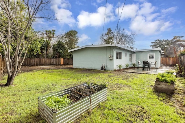 back of house featuring a lawn and a patio