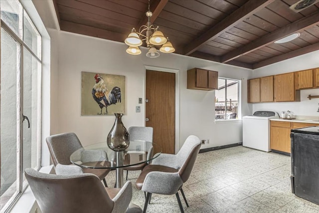 dining area with washer / clothes dryer, a notable chandelier, wood ceiling, and beam ceiling