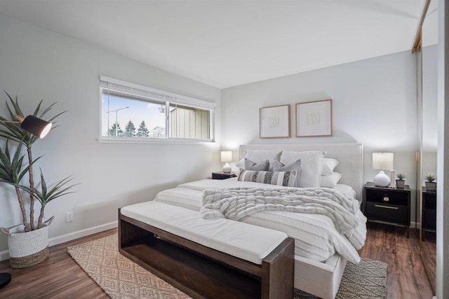 bedroom with dark wood-type flooring